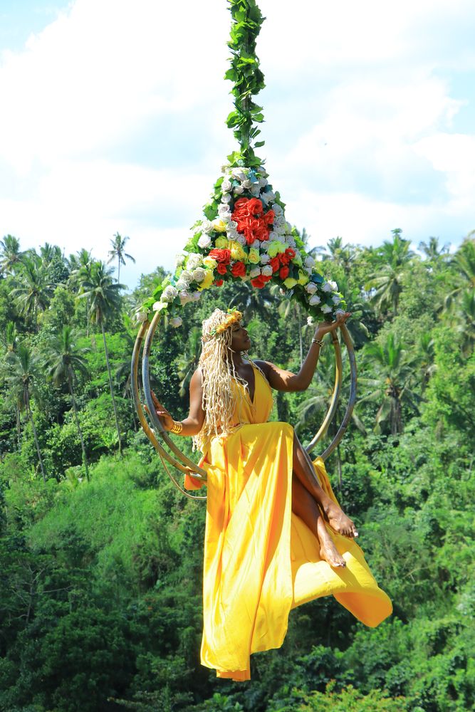 On the flower swing above the palms
