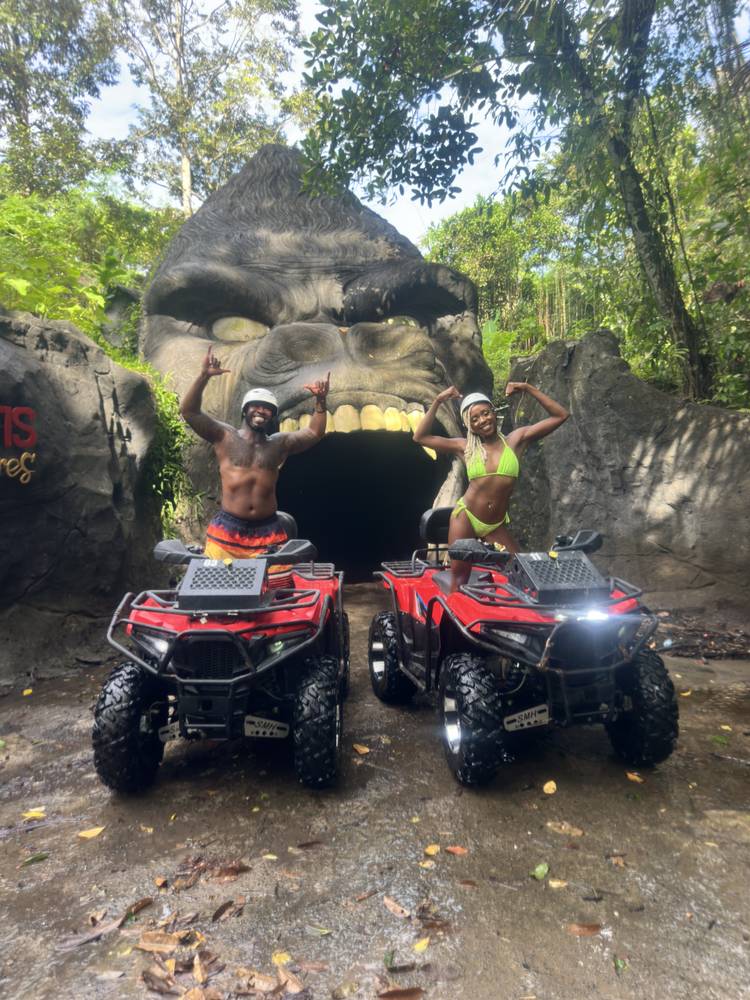 Posing at the carved cave entrance