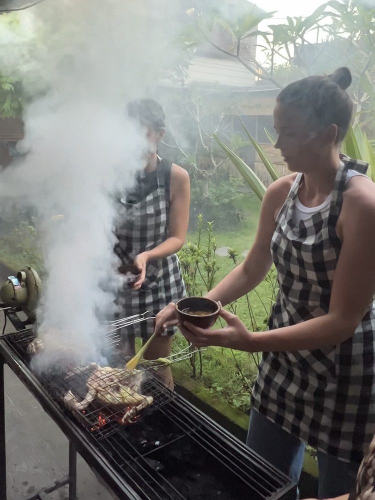Grilling over coals, basting as it goes