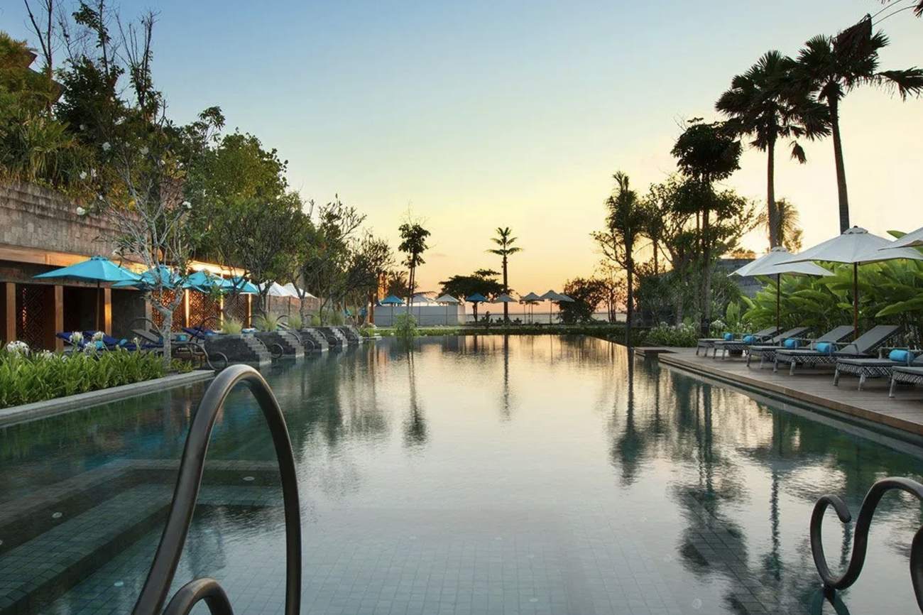 The beachfront pool at Hotel Indigo Seminyak at sunset